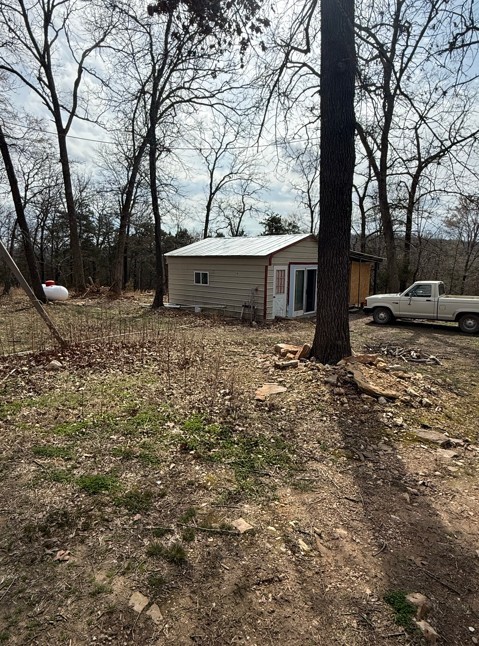 This quaint 6.82 acre property near the lake has a lot to offer. The property features a detached storm shelter, approx 4 acres of cleared land that previously housed horses, the property does have some cross fencing to accommodate your equestrian liking. Additionally, the property features an approx 400 sqft 1 full bath studio style cabin complete with Refrigerator, Stove and microwave. There is also a washer and dryer. The gas tank is owned by the owner of the property, and it will convey. But wait, there's more! This 6.82 acre property backs up to a couple hundred acres of prime Corps Land and features a wide trail all the way to the water edge of Bull Shoals lake. This property is pretty flat, as is the Corps Land that surrounds it on 2 sides. Dont miss your opportunity on this income property, or your own little lake area getaway!