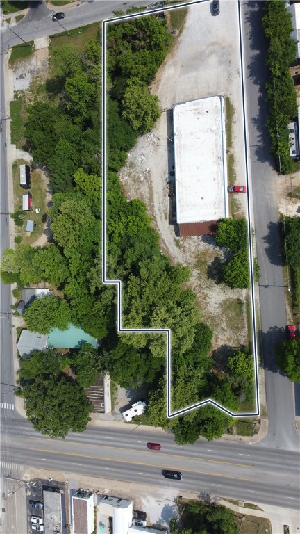 Amazing potential in a prime location with endless possibilities! This property is minutes from the University of Arkansas, Fayetteville Square, and adjacent to the Razorback Greenway. Versatile property that can used as an office, commercial warehouse, industrial space, or food beverage/music. Property is zoned Downtown General. The property neighbors the Tanglewood Branch Creek offering offering a unique amenity. Opportunity awaits!