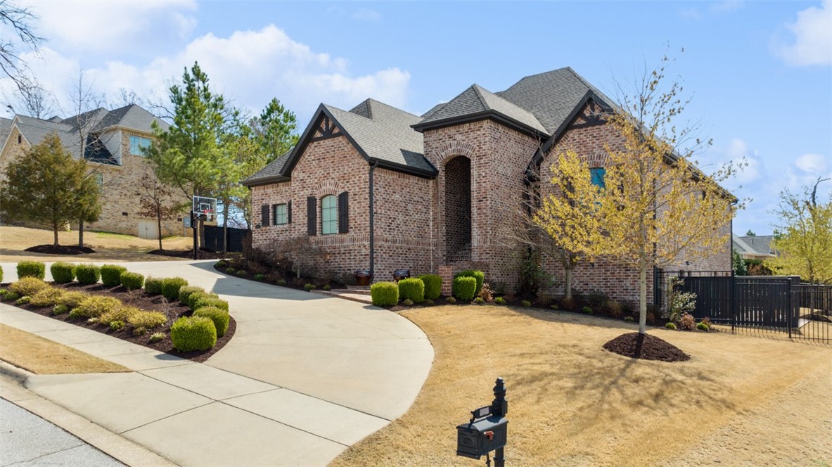 Welcome to luxury living in the gated community of Heritage Hills! With professional design touches, open floor plan and a backyard oasis, this home will leave you wanting for nothing. Walk into a free-flowing layout on the main level where you can host lively game nights with friends & family or cook to your heart's content in the chef's kitchen. When it's time to relax, retreat to your peaceful and private master suite. Downstairs features amazing space for you to entertain including a game room, wet bar and second living area. If outdoors is where you want to be, you can chill at the pool, toast S'mores around the fire pit or watch the big game in front of the fireplace on your covered deck. When you do have to leave your private paradise...you'll find work, shopping and schools are close by with easy access to I-49.  You won't want to be gone for long! Visit www.3075heritagehillsdrivespringdale.com for more information.