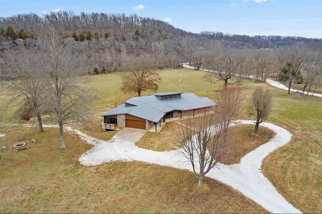 Renovated in 2022, this home offers stunning views and abundant natural light, thanks to expansive windows and skylights. Enjoy outdoor living with a spacious back porch on the main level and a covered patio below. The property features two separate two-car garages—one on the main level and another at the rear lower level. Ideally situated near Bentonville’s Handcut Holler Trailhead, Brush Creek River, and scenic rustic gravel road connectors, this location is perfect for outdoor enthusiasts.