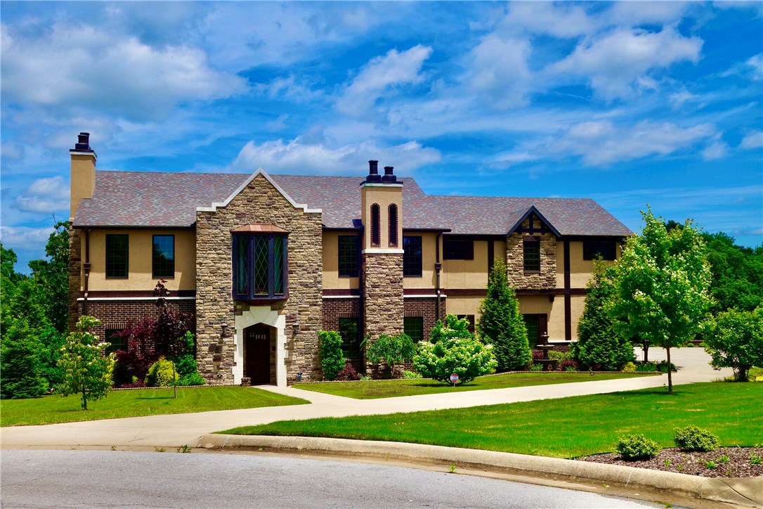 Gorgeous custom Tudor home, full of old-world charm with modern upscale amenities. Soaring 22' ceiling in kitchen, breakfast and family rooms. 6 x 9 island with cooper apron sink, 2 dishwashers, china storage, 6 burner gas stove with griddle; breathtaking woodwork and details throughout. Ample outdoor entertaining options, overlooking stunning salt water pool with copper waterfalls. Outdoor kitchen and oven, outdoor shower! Every bedroom has private bath. Home featured on HGTV's "House Hunters" season 178, "Building Battle in Arkansas" (2019).