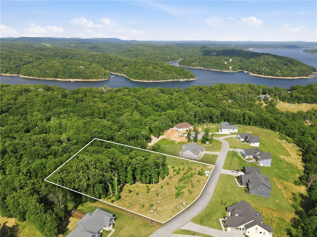 Build your dream home in one of the area’s most stunning lake communities! This beautiful 2-acre lot offers the perfect blend of privacy, space, and access to the lifestyle buyers dream about. Surrounded by upscale homes on large estate-sized lots, the setting feels peaceful and tucked away while still offering convenient access to everything Northwest Arkansas has to offer. Enjoy easy access to Beaver Lake with a community boat dock and a private boat slip that conveys with the property—making lake days effortless from the very beginning. Whether you’re planning a full-time residence or a luxury getaway, this lot provides the ideal backdrop for outdoor living, entertaining, and enjoying the natural beauty of the Ozarks. Rare opportunity to own acreage, lake access, and a private slip all in one exceptional community.