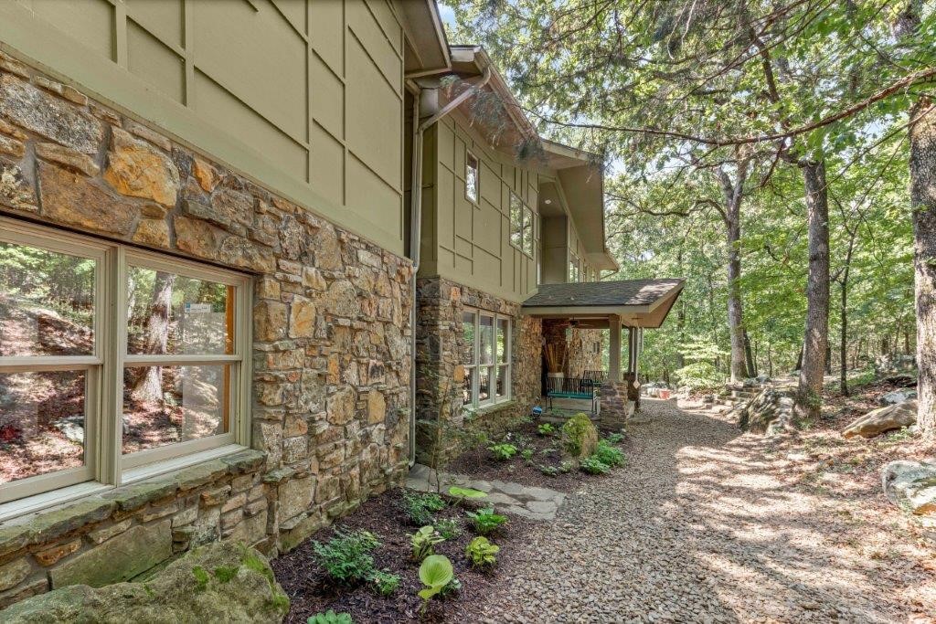 NEW Roof as of June 2024! Experience Rockwood’s stunning contemporary craftsman architecture set in a beautiful park like forest w/7ac of mature hardwoods & hundreds of lichen & moss covered boulders. Only 15 min from Fayetteville & located in sought after Goshen community. With 89 windows & open concept design, bask in nature from the comfort of your geothermal climate-controlled home. Main living area features two 22' high floor to ceiling glass walls & natural stone fireplace w/ massive hearth stone & stone mantel from the home site. Custom solid oak detailed millwork & cabinets throughout home. Kitchen boasts granite counters, gas range & walk in pantry. Every bedroom has large WIC’s. 2 Guests Bedrooms each w/guest bath access. Primary suite w/balcony and spa like bath retreat. Huge bonus room. Property also features a 2400 SF heated & cooled shop built in 2020 w/epoxy floors, 480 square foot second floor & separate metered 110/220 200 Amp electric. Potting shed & predator proof chicken coop & run w/feed room.