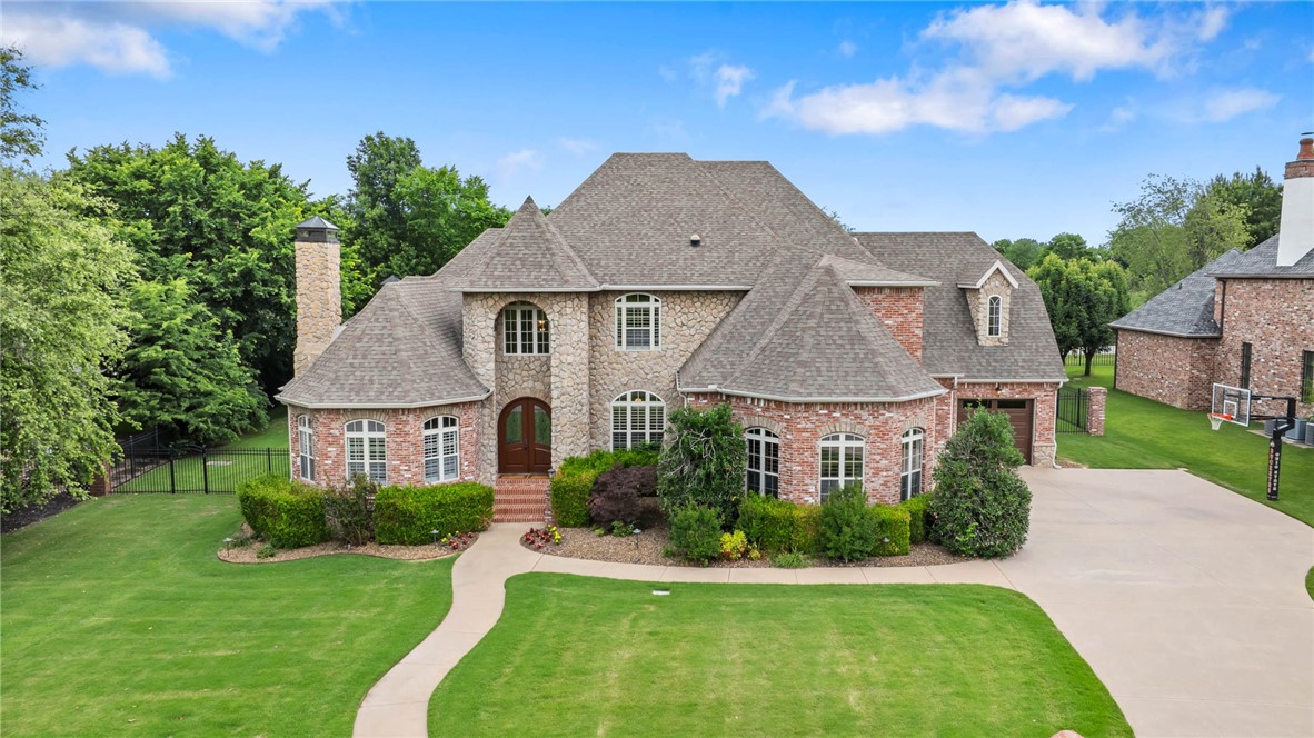 Located in gated Pinnacle Country Club & zoned for both Rogers & Bentonville schools, this updated 5,331 SF home sits on a private half-acre lot with a highly sought-after floor plan. Nearly 3,600 SF on the main level, the home offers 5 bedrooms, 6 baths, executive office, additional study, multiple living/dining areas, hardwood flooring, updated lighting, fresh interior paint & 4 fireplaces. The remodeled kitchen features updated cabinetry, designer island with quartzite countertops, panel fridge/freezer & stainless appliances. Main-level primary suite includes fireplace, pool views, backyard access, luxury bath & oversized closet. Upstairs offers 4 large bedrooms, including 2 ensuites, Jack-&-Jill bath & loft. Outdoor living includes heated saltwater gunite pool, refreshed cool deck, Sonos whole-home sound, pool house with fireplace, grill, beer tap, shower, bath & storage. 3-car garage with epoxy floors, new garage doors, tornado shelter, Ring security & walkable location near AMP, dining, shopping, golf & I-49.
