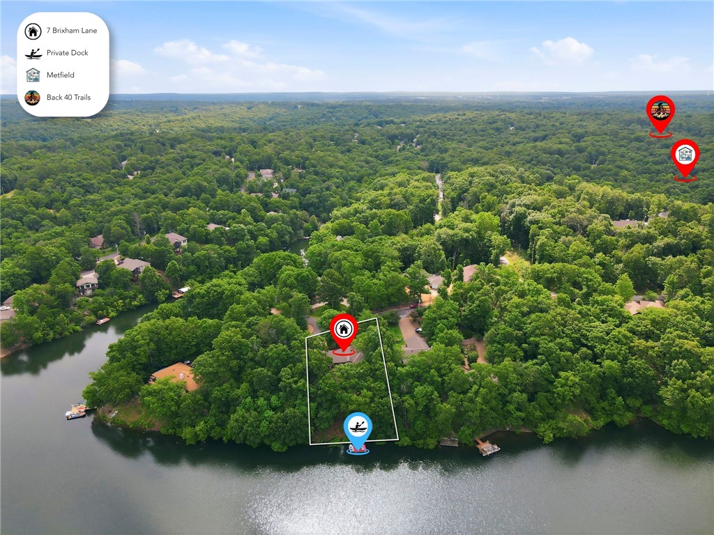 Embrace lake life on Lake Brittany in Bella Vista — a private dock retreat built for the outdoor lifestyle, close to everyday conveniences. This updated 3BR, 3BA home blends privacy and quality. The kitchen features white cabinets, granite countertops, stainless steel appliances, electric cooking, and a pull-out pantry. A wood-burning fireplace anchors the living room with 12' ceilings, while the dining/sunroom captures 180° lake views. Additional spaces include a bonus room, game room, office, and attached storage/workshop. The primary suite offers a glass shower, walk-in closet, and private deck access; two additional bedrooms also have walk-in closets. Recent updates include a newer roof, HVAC, water heater, windows, French drains, dual sump pumps with battery backup and landscaping. Savor peaceful days minutes from Metfield pool, pickleball, golf, Back 40 trails, Razorback Greenway, OZ Trails Bike Park, downtown Bentonville and schools, Crystal Bridges, Walmart HQ, the AMP, and the University of Arkansas.