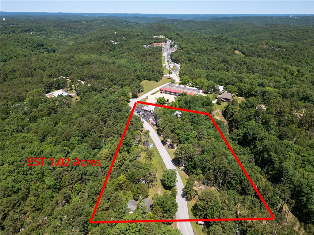 Exceptional income-producing property with over 1,000 feet of highway frontage on both sides of the road leading into the entrance of America’s most attended outdoor drama, seen by more than 7.7 million visitors. This 5-acre setup is already generating revenue through active billboards, vendor partnerships, and a licensed food truck, with even greater potential for mini storage, flea market vendors, RV camping, tiny homes, or expanded market space.

The property includes two residences: a charming historic home and a cozy cottage, offering living space or rental opportunities. A camping layout has already been designed, adding further versatility for development. With city water, electric, and no restrictions, the possibilities are wide open.

This high-traffic, high-visibility location combines strong existing income streams with endless potential for expansion. An unparalleled opportunity for investors and entrepreneurs in a rapidly growing destination.