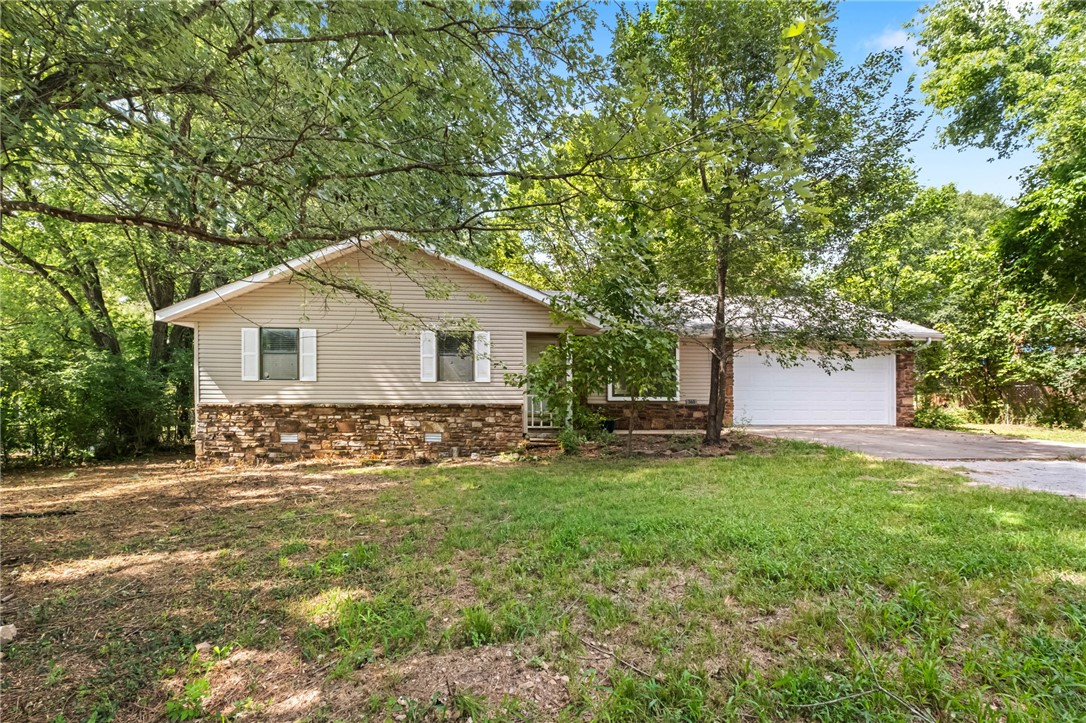 Nestled on 0.46-acre lot in the Goshen city limits, this charming home offers a wonderful opportunity for its next owner to truly make it their own. Surrounded by mature trees, the spacious yard provides plenty of privacy & room to create the garden or outdoor retreat you've always wanted. Inside, you'll find 3 bedrooms, 2 full bathrooms, & an eat-in kitchen with all appliances conveying. The inviting living room features a cozy cabin-inspired feel that's perfect for relaxing after a long day. Conveniently located near the Goshen Community Center, which has events & a walking trail, this home is also close to the local farmers market & is zoned for the Fayetteville School District. The home is being sold AS-IS, seller will make no repairs & the property is not eligible for FHA, VA, or RD financing. Current American Home Shield home warranty will transfer to buyer. If you're looking for a home with great potential, a spacious lot, & a great location, this is one you won't want to miss!