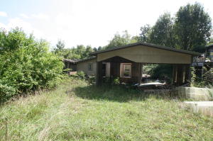 The value is in the land.  Mobile home on the property and old house need extensive repairs Back of the property butts up to national forest land.  Located right off Highway 7. Property is sold ''As Is, Where Is'' with no repairs.  Close to Hurricane Creek area.
