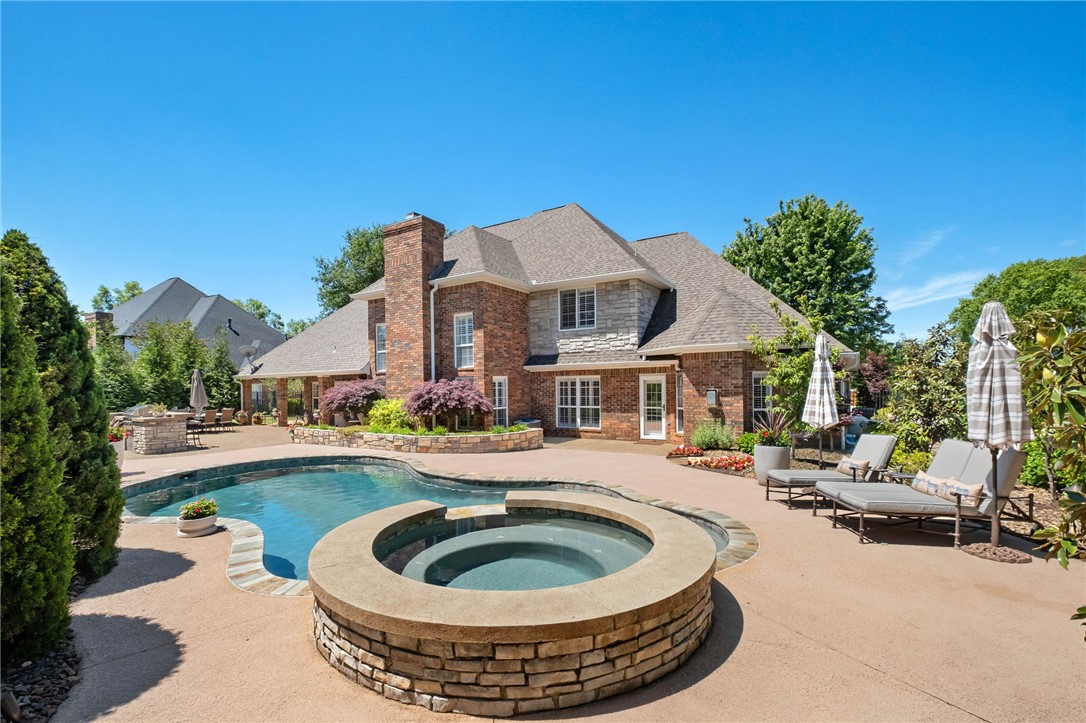 This beautifully updated residence in the prestigious gated community of Pinnacle Country Club offers an exceptional blend of timeless elegance & modern comfort. Spanning approximately 4,450 sq ft, the home features 5 bdrms, 4 full baths, & 1 half bath with thoughtfully designed living spaces ideal for both everyday living & entertaining. A dramatic great room showcases soaring cathedral ceilings & fireplace, while the gourmet kitchen is beautifully appointed w/marble countertops, double ovens, & an inviting eat-in dining area. Additional interior spaces include a formal dining room, private study, & spacious second living area offering flexibility for guests or recreation space. Situated on a beautifully landscaped 0.60-acre lot, the outdoor living experience is equally impressive with a sparkling pool & spa, outdoor kitchen, & fireplace designed for year-round enjoyment. Completing the property is a desirable side-entry 3-car garage, all within one of Northwest Arkansas’ most sought-after golf course communities.