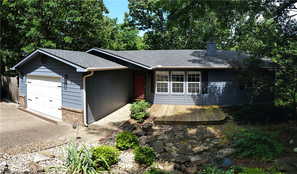 Nestled among the trees and backing directly to the Lago Vista Spur Trail, this updated Bella Vista home offers privacy and outdoor access just minutes from Lake Avalon. The spacious floor plan features a large living room with a brick fireplace, updated kitchen with stainless steel appliances and subway tile backsplash, built-in dining storage, a bonus room, and remodeled bathrooms. The primary suite includes a walk-in tiled shower and a large walk-in closet. Enjoy the expansive deck overlooking the wooded backyard. The insulated workshop/storage building features air conditioning and a wood-burning stove, making it ideal for hobbies, a workshop, or additional storage. Conveniently located near lakes, trails, golf, and all of Bella Vista's amenities.
Roof, guttering, gutter guards, & water heater replaced in 2023.