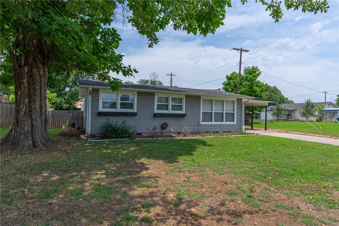 Move-in ready & located in a well-established neighborhood you'll discover an updated modern Eat-in kitchen with open shelving & large sink. The spacious laundry area with a barn door and extra storage space, enhances the functionality of the home. With beautiful original hardwood floors and ceramic tile there is no carpet, ensuring easy maintenance. Cozy & Charming currently a two-bedroom layout, the house was originally a three-bedroom design. The master bedroom was expanded by removing a wall. However, with all the doors and closets still in place, it can easily be converted back into a three-bedroom configuration to suit your preferences. Outside is a fenced backyard and a deck right off the kitchen providing outdoor relaxation additionally there is an 8X12 storage building and a carport to meet your storage and parking needs.