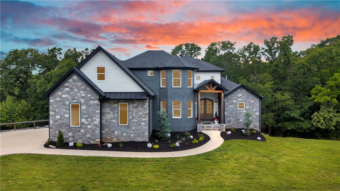 Showings Start Friday 6/5! Open House Saturday & Sunday. Luxury, Privacy, and Timeless Craftsmanship! Stunning 2023 custom estate on 2 private wooded acres in the gated Estates of Lakeway. Designed for effortless entertaining and everyday comfort, the open floor plan flows beautifully, creating an inviting atmosphere filled with natural light and upscale finishes. The luxurious primary suite serves as a private sanctuary, complete with a cozy fireplace, sitting area, and direct access to the expansive patio. A fully finished walkout lower level offers exceptional flexibility with private living space ideal for guests, a media lounge, multigenerational living, & the ultimate retreat. Surrounded by mature trees and exceptional privacy, the outdoor living spaces provide the perfect setting to relax, entertain, and enjoy peaceful evenings. With access to three community docks, this property offers a rare opportunity to enjoy the privacy of a wooded estate paired with the recreation and lifestyle of Beaver Lake living.