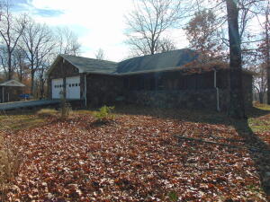 2 bed 2 bath home in beautiful park like setting.  Exterior of house is in custom designed rock. Lots of oak cabinets in kitchen and laundry room.  Master bed has walk in closet plus bathroom and the second bedroom also has its own bathroom.  Sun room is fully enclosed with free standing wood stove.  Fruit trees in front with lots of wildlife including deer and turkey.