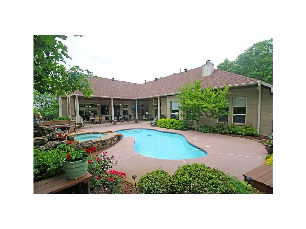 Don't let this one slip by great location great value! Custom built estate home in a gated community located in the heart of Fayetteville. This home welcomes you with an elegant entry adorned with marble floors, stunning architectural design, custom finish columns & beautiful windows overlooking the backyard pool, waterfall and hot tub it's an amazing oasis. It boasts 2 living spaces, kitchen, formal dining, three bedrooms and 2 baths on the main floor. Walk-out basement has an amazing media room complete with a kitchenette, two bedrooms & two baths and would be an excellent mother-in-law suite. This home is a must see to appreciate all of the custom amenities it has to offer. You can't build today with these features at this price!
