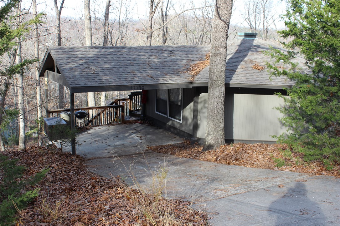 Charming 2 bdr/1 full bth open floor plan! Every inch of space is utilized to perfection. Perfect getaway to relax and enjoy all the lake has to offer. Minutes from LBV boat launch. Move in ready with fresh paint, flooring, appliances and roof. Spacious outdoor deck and floor to ceiling windows allow you to take in the beauty of the lake. Attached carport keeps your vehicle or lake toys safe from the weather. Included 3 surrounding lots create great buffer. Would be awesome income producing rental!