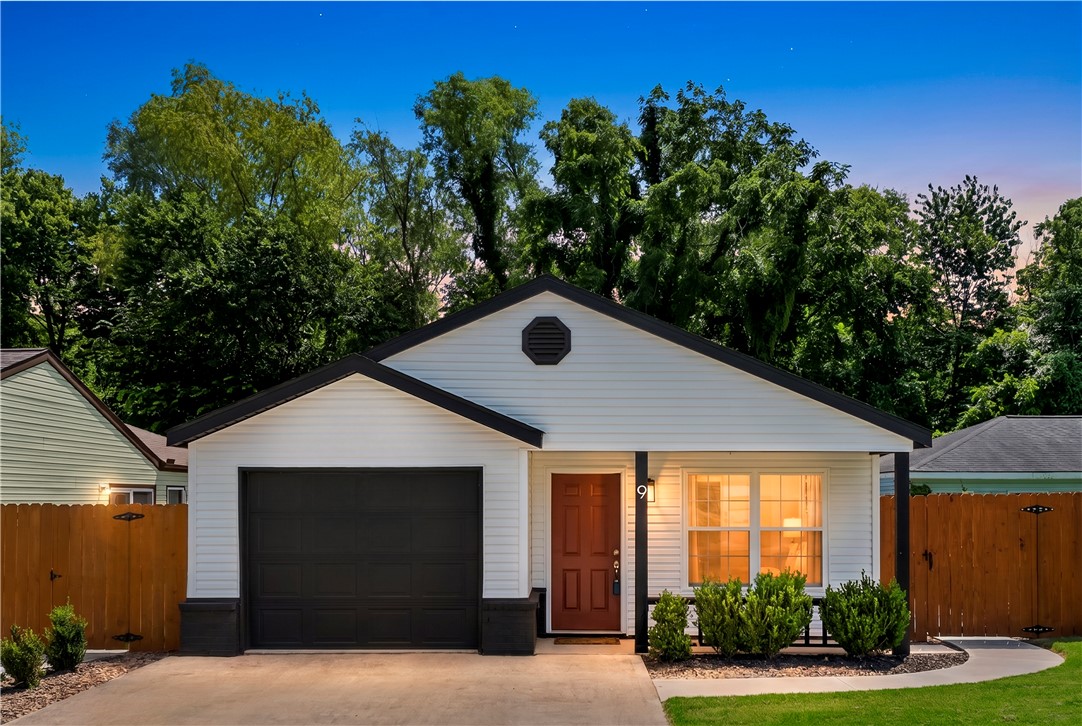 Completely remodeled and move-in ready in the heart of Bentonville! This 3 bedroom, 2 bathroom home offers stylish updates throughout with fresh paint, new LVP flooring and carpet, new showers and tubs, a new sliding door, and an open, inviting layout with a wood burning fireplace for those chilly nights. A new refrigerator, washer, and dryer convey with the new oven and microwave rounding out a set of worry free appliances. Outside, enjoy newly built composite decking connecting right to the patio, fresh backyard landscaping, new privacy fencing, and a new sidewalk from the patio to the driveway for easy access and functionality. The backyard is also grass free for very low maintenance. The garage features a newly sealed floor, adding a clean finished touch and a new wifi connected garage door opener. Located just steps from biking trails and only 1 mile from downtown Bentonville, this home combines modern updates with an unbeatable location close to dining, entertainment, and everything the city has to offer.