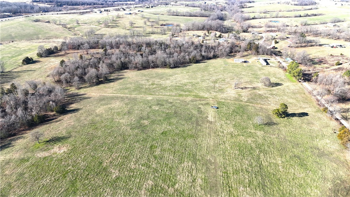 Don't miss this prime tract of land ready for your new home build! Mostly open, all useable 13.31 acres provides a country feel with room to breathe.  Great access with county road frontage and short distance to pavement. Rural water, electric, fiber at road. Quick access to Hwy 412 and nearby amenities, 25 minutes to Fayetteville/Springdale. This scenic property combines an ideal out of town setting with convenience to necessities. Call for an appointment to take a look today! Utility availability is the responsibility of the buyer or buyers agent.