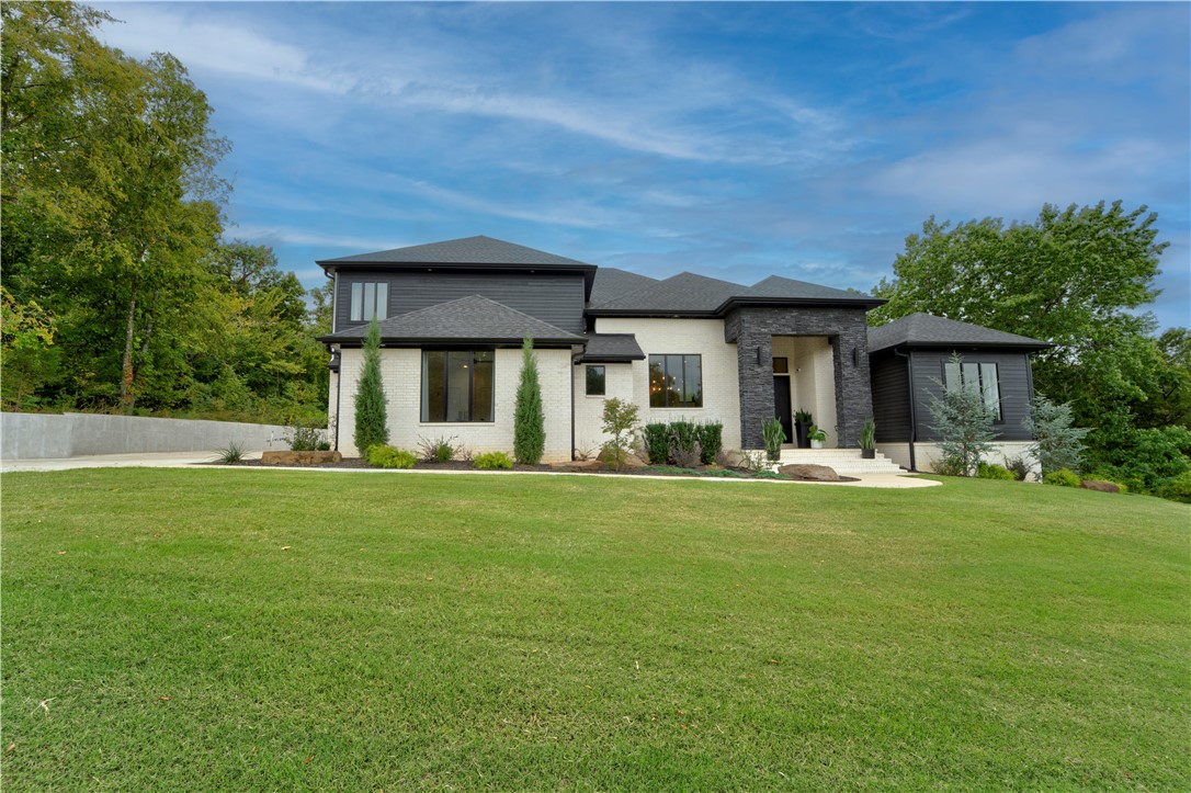 Looking for a beautiful home in East Fayetteville? You're in luck! This beautiful home sits on just over an acre in one of Fayetteville's best neighborhoods. With a large, open, and modern feel this home offers an amazing layout for hosting friends and family. With 5 bedrooms, 4 full baths, a main level office, and a walk in laundry room it is perfect for a large family. You will be near multiple elementary schools, McNair Middle School, and Fayetteville High School. To top things off, you walk out onto a large, covered patio that looks out at the backyard with a lot of mature trees and tons of privacy.