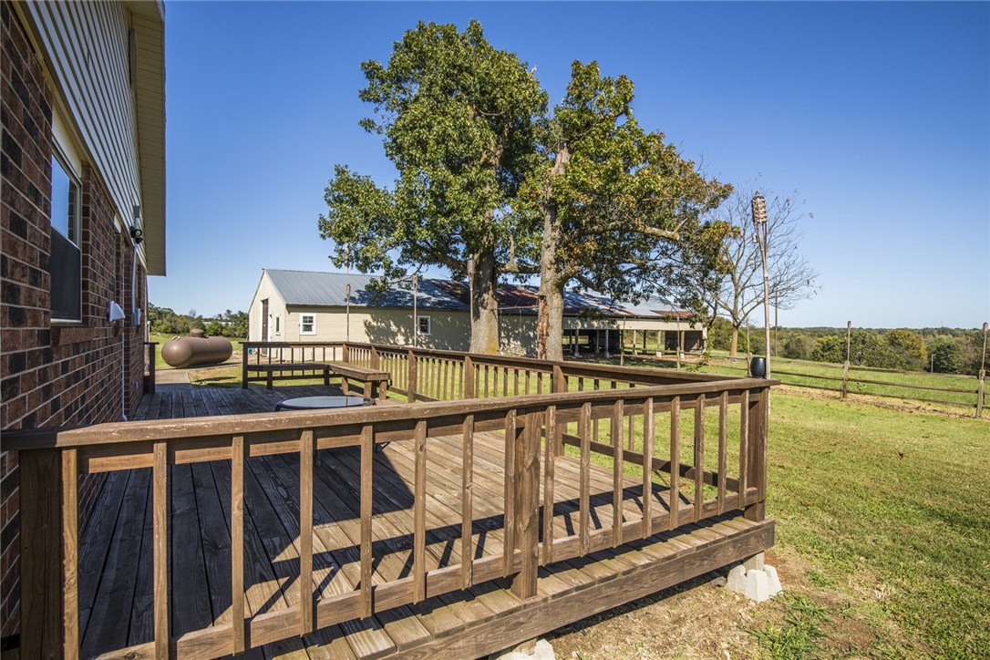 BUYER FINANCING FELL THROUGH--BACK ON THE MARKET -   5.26 acres + home + outbuilding in the middle of town!  Looking for the perfect home with land in the Bentonville School District.  This home has endless possibilities.  This property, located just outside of Bentonville, has plenty of room to enjoy, add on, or build.  With solar panels on this 3 bedroom/2 bathroom home, you are sure to enjoy very low utility bills.