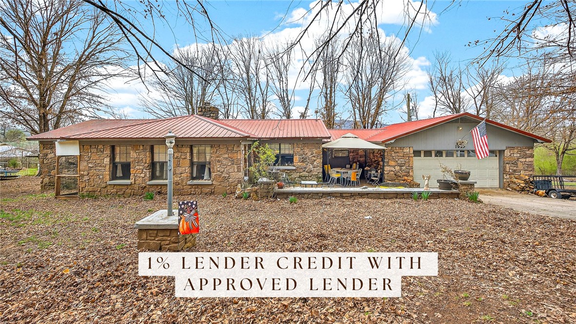 1% Lender Credit with Approved Lender! Experience the best of country living in Mountainburg! This comfortable 3-bedroom, 2-bath home on just under an acre boasts a native stone exterior topped with a sleek, metal roof. Kick back and relax in the spacious living area and functional, eat-in kitchen with storage galore. This rural charmer also features a large 30x60 (Approx.) shop, complete with its own electric meter and woodburning stove. Tucked away in the heart of the Boston Mountains, Mountainburg is roughly 30 minutes from Fayetteville, 30 minutes from Ft. Smith, 10 minutes from Alma and 10 minutes from Lake Ft. Smith. What better place to enjoy quiet, peaceful country living than in the very heart of the Ozarks!