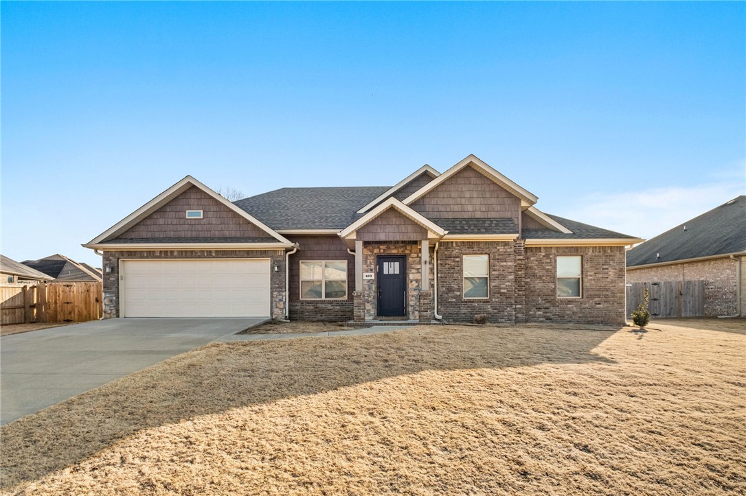 Well-maintained 4-BR, 2-BA home in Prairie Grove with quality finishes and a functional layout. The kitchen features white custom cabinetry, granite countertops, a gas cooktop, built-in oven & microwave, under-cabinet lighting, & center island. Formal dining area opens to the living room with a fireplace, custom mantel, tray ceilings, stained beams, and shiplap accents. Additional features include built-in bookshelves, manufactured wood flooring throughout the living areas & primary bedroom, & functional laundry room complete with sink &custom locker system. The primary suite has tray ceilings, crown molding, an accented shiplap wall, and two walk-in closets. Primary bath offers a custom tiled shower, double vanity, whirlpool tub, & linen closet. Enjoy outdoor living on the covered back patio, plus the convenience of an oversized 2 car garage, wood privacy fence, gutters, wide doorways, abundant storage, & more. This home has it all!