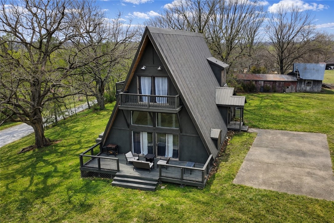 Great investment or Airbnb opportunity. An A-frame roofline and a metal roof catch the eye from the end of Cooper Drive, giving this two-story home a profile that reads more mountain lodge than suburban ranch with the first story renovated. Built in 1989, the four-bedroom, two-bath layout spreads across 2,794 sqft on a 2 level floorplan with a bonus room and a bonus living area, keeping every room accessible from a central hallway with a multiple staircases to navigate through both inside and out. A wood-burning fireplace anchors the main living area, where the pitched ceiling follows the A-frame structure upward, opening the room vertically and letting light travel deep into the interior, Central heating and cooling keep the climate steady year-round. The lot itself is the headline: 2.19 acres in Benton County, giving the property a setback from neighbors that most residential parcels simply cannot offer. Your next home awaits you, come check it out!