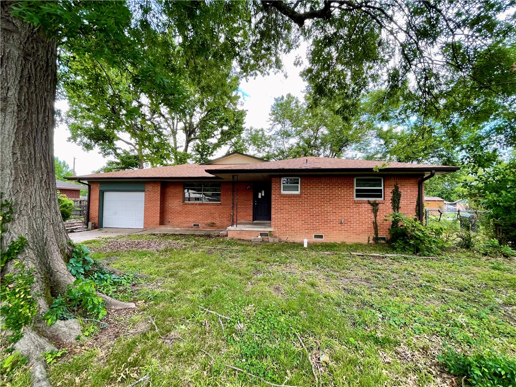 Welcome to this charming 3-bedroom, 3 bath, brick home located in convenient Central Springdale! This property boasts a covered front stoop and large, mature shade trees. Inside, you'll find two spacious living areas, one featuring a cozy hearth fireplace, providing plenty of room for entertaining and relaxation. The eat-in kitchen showcases beautiful granite countertops. The three bathrooms are updated with stylish tile surrounds in the shower and combo tubs/showers. Additional functional spaces include a flex room that would make a great office and a convenient utility/mudroom. Enjoy your morning coffee on the covered back patio overlooking the fenced backyard with storage building. Complete with a 1-car garage and a great location near Huntsville Ave, restaurants, and shopping, this home is ready for its new owner! Back on the market at no fault of Seller.