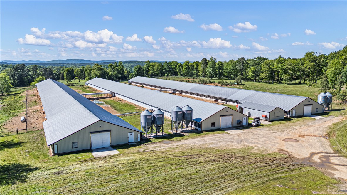 Welcome to this Handsome Brooks Egg Farm — a beautiful, income-producing property nestled atop the stunning Ozark Mountains. Situated on 80+/- acres, this is a rare opportunity to own a thriving pasture-raised egg operation in one of the most scenic settings in the region. (DO NOT ENTER FARM WITHOUT LISTING AGENT)
At the heart of the property sits a magnificent 2,402 sq ft log cabin featuring an open living area with a fireplace, a spacious kitchen, a loft, and sweeping mountain views the perfect place to call home while running your operation. Beside the main residence is a three-bay shop, and multiple outbuildings across a beautiful blend of wooded acreage and wooded pasture, with abundant wildlife throughout.
The farm features two laying barns and one packing barn built in 2009, the packing barn is equipped with an egg packer and cooler, with excellent storage space as well. 
A second residence is also included and with some updating could serve as ideal farmhand quarters, this residence is being sold AS-IS.