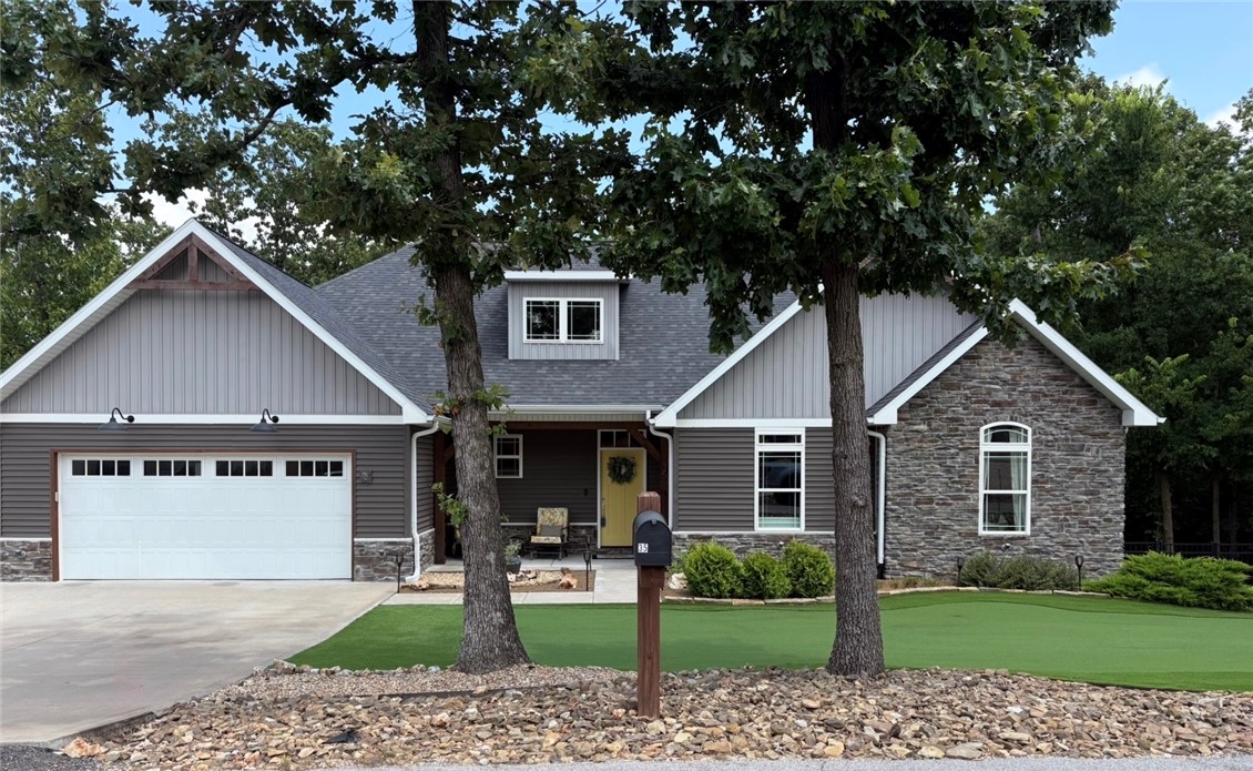 You don't want to miss this beautiful custom-built 3-bedroom, 2-bath home tucked away on a quiet street in Bella Vista and situated on a spacious double lot. The low-maintenance front yard features a turf putting green that provides year-round curb appeal. The private backyard includes a fire pit and backs to POA-owned land, offering wooded views and no homes directly behind. Oversized double doors open to the deck, creating seamless indoor-outdoor living with peaceful treehouse views. The walk-out crawl space with a concrete pad offers endless possibilities for storage, a workshop, home gym, office, or hobby space (buyer to verify use). The oversized 2-car garage provides additional room for a workbench or projects. Located just minutes from Lake Loch Lomond, this home combines privacy, flexible space, and easy access to one of Bella Vista's premier lakes.  Included with your POA membership  gives you access to 7 private lakes, 7 golf courses, 3 top of the line fitness centers and many more amenities.