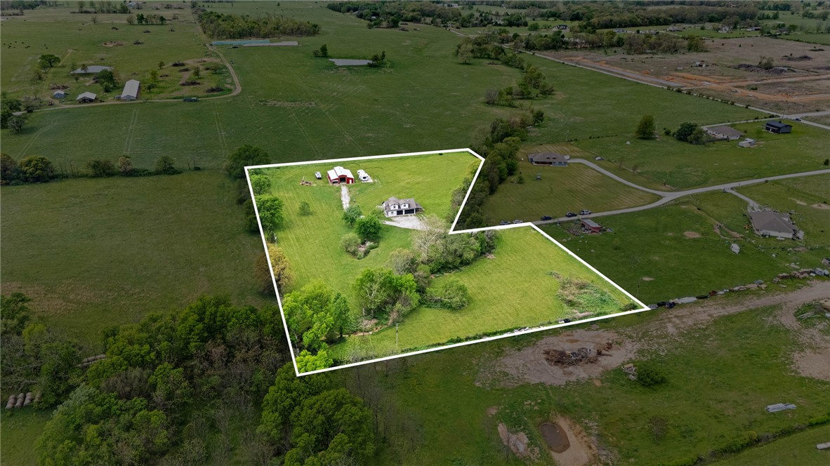 You have found a piece of paradise tucked into the heart of Northwest Arkansas. This stunning 5.62-acre property features  a home with 3 bedrooms, 2 baths, multiple other building sites and is surrounded by incredible views. The impressive 40x50 shop with loft is ideal for storage, hobbies, or a workspace. The home also features a safe room/tornado shelter located in the garage. RV hook-ups and parking site already installed. This is an exceptional opportunity to own a beautiful piece of land just minutes from top amenities, shopping, dining, and ongoing development.

This is an As-Is Sale. Property disclosure is available.