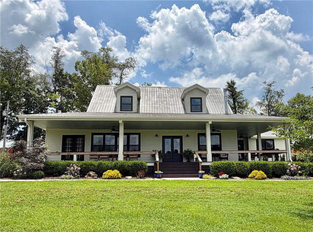 Beautifully-renovated Farmhouse on 7.5 Acres, only 15 Minutes from downtown Fayetteville!  The property features breathtaking sunset views, a peaceful pond, and lush fields that gently roll up to the house & pond.  Guest Apartment above the extra-spacious detached garage.  Brand new 8-foot privacy fence just added!  Upgrades in 2023 include a stunning kitchen with quartz countertops, an over-sized shower in primary bath, and new windows, flooring & paint.  Both the house and the grounds have been so well maintained, and the 50'x42' barn is ready to go with water & electric.  Relax on the classic wraparound front porch, or by the Mimosa trees at the pond.  The office in the primary bedroom can double as a walk-in closet.  This combination of extra acreage and proximity to Fayetteville is a rare find.  The metal roof and high-quality siding make this home even more appealing for long-term upkeep.  Don't miss this opportunity for a taste of country living that's not too far removed, schedule a showing now!