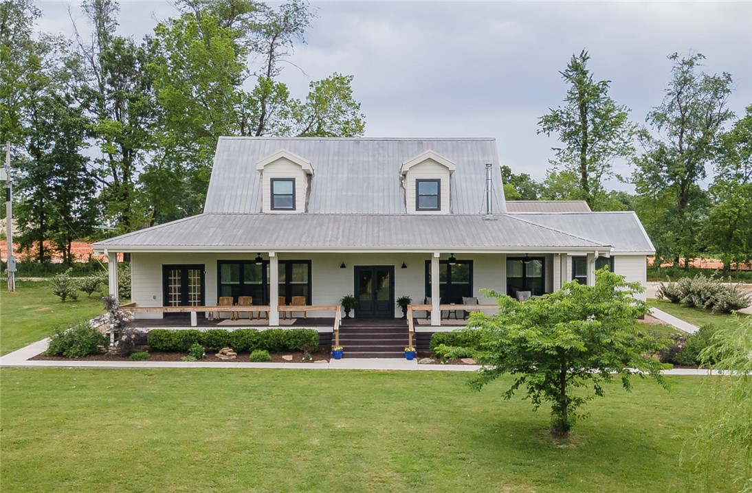 Beautifully-renovated Farmhouse on 7.5 Acres, only 15 Minutes from downtown Fayetteville!  The property features breathtaking sunset views, a peaceful pond, and lush fields that gently roll up to the house & pond.  Guest Apartment above the extra-spacious detached garage. Upgrades in 2023 include a stunning kitchen with quartz countertops, an over-sized shower in primary bath, and new windows, flooring & paint.  Both the house and the grounds have been so well maintained, and the 50'x42' barn is ready to go with water & electric.  Relax on the classic wraparound front porch, or by the Mimosa trees at the pond.  The office in the primary bedroom can double as a walk-in closet.  This combination of extra acreage and proximity to Fayetteville is a rare find.  The metal roof and high-quality siding make this home even more appealing for long-term upkeep.  Don't miss this opportunity for a taste of country living that's not too far removed, schedule a showing now!