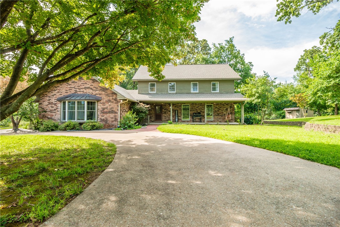 Welcome to 3168 Ozark Acres Drive, a rare 3.41 acre estate located minutes away from all the area favorites. A dreamy, tree-lined drive leads to the southern living style home with a welcoming front porch overlooking picturesque equestrian farmland. The 3,701 sf home features wide plank hardwood flooring, custom millwork, wood windows & doors filtering in natural light, updated lighting, & gorgeous property views from every room.  The main level features two living areas, formal dining room with wainscoting, a charming kitchen reflecting a true farmhouse style, spacious utility/mudroom, & a bonus recreation room. The second level hosts the primary ensuite with 3 additional bedrooms and a full bath, while the third level offers a large bonus room with a 5th bedroom & bathroom. Step outside to an expansive deck, fenced-in garden area, & 4-stall horse barn with electricity, Dutch stall doors, tack storage area, groom room & wash stall. This home offers an unmatched lifestyle for the whole family!  Property sold As Is.