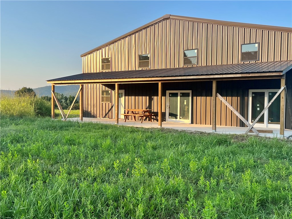 Location! A RARE opportunity to own a 100 acre Barndominium Homestead Located in Crosses off HWY 16, the famous “pig trail” 20 min to Fayetteville & quick access to White River. This beautiful acreage boasts magnificent views, 20 acres pasture, 80 acres woods, a 3000 sq ft mid-construction barndo including 1575 sq ft attached workshop, 1 large overhead & 1 reg garage door. An open floor plan w soaring ceilings. Kitchen w/extra large pantry & island open to a Great Room & Loft. Mud rm, Utility rm adjacent & a very generous Primary Suite just off the Great Room. 2nd floor features a 2nd living space w bed/bath, lg. library & loft. See floor plan attached. Natural gas, electric, water tap & well already in place. Breathtaking creek perfect for cooling off during hot summer days, or for perch & bluegill fishing. So much of the work is already done for you! For your recreation, the timber found throughout creates an amazing habitat for deer, turkey, black bear, and much more! Come see this hard to find acreage in NW AR.