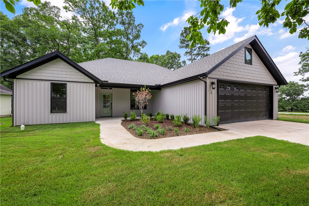 New construction opportunities offering both golf course views and Table Rock Lake access are rare in Holiday Island! Located behind the 3rd tee box of Holiday Island Golf Course and just 2 miles from Holiday Island Marina, this move-in ready split-bedroom 3 bed/2 bath home delivers the lifestyle buyers are searching for. Inside, enjoy an open-concept design with a brick gas fireplace, quartz countertops, LG stainless appliances, gas range, walk-in pantry, LVP flooring, curated lighting, and luxury finishes throughout. The private primary suite is thoughtfully separated from the guest wing and features a walk-in closet, ensuite bath, soaking tub & laundry access. Thoughtful upgrades include 8" baseboards, tall-framed windows, a drop zone, 4' x 10' garage storage room, attic storage, tankless water heater, spray foam-insulated interior walls, gutters, a 500-gallon propane tank, and covered front & back porches. Receive $2,500.00 towards buyer's closing costs when working with the builder’s preferred local lender!