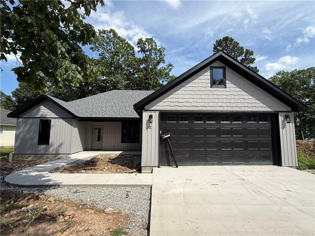 New construction opportunities offering both golf course views and Table Rock Lake access are few and far between in Holiday Island! Located behind the 3rd tee box of Holiday Island Golf Course with views of the 2nd tee box and just 2 miles from Holiday Island Marina, this move-in ready split-bedroom 3 bed/2 bath home delivers the lifestyle buyers are searching for. Inside, enjoy an open-concept design with a brick gas fireplace, quartz countertops, LG stainless appliances, gas range, walk-in pantry, LVP flooring, curated lighting, and luxury finishes throughout. The private primary suite is thoughtfully separated from the secondary bedrooms and features a walk-in closet, ensuite bath, soaking tub and laundry access. Thoughtful upgrades include 8" baseboards, tall-framed windows, a drop zone, 4' x 10' garage storage room, attic storage, tankless water heater, spray foam-insulated interior walls, gutters, a 500-gallon propane tank, and covered front and back porches. Don't miss your chance to make it yours!