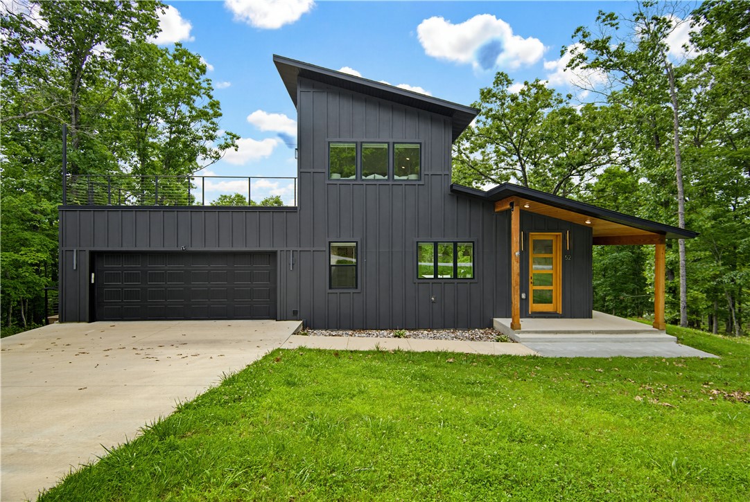 What if your backyard connected directly to a world-class mountain biking trail system? Located right off Tunnel Vision Trail and just minutes from the brand-new OZ Bike Lift Park, this like-new home offers modern living with multiple levels of living space designed to flex with your lifestyle, there's room for everyone to live, work, and play. Outside and enjoy three exceptional outdoor living areas, including an incredible oversized patio above the garage with breathtaking views perfect for hosting guests, enjoying sunsets, or relaxing with your morning coffee. Two additional covered patios provide even more space to unwind and take in the surroundings. This home embodies everything that makes Northwest Arkansas so desirable outdoor adventure, stunning views, and a lifestyle you'll love, 52 Chatburn is the one!