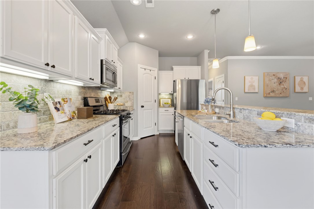 This 3 bed, 2 bath move-in ready home features a thoughtfully designed split floorplan with an open-concept layout, seamlessly connecting the living, kitchen, and dining areas. The kitchen includes granite countertops, a gas range, pantry, and barstool seating overlooking the living room with fireplace, creating a functional space for both everyday living and entertaining. A true split floor plan, the private primary suite is separated from the secondary bedrooms for added comfort. Out back, a spacious yard borders to pasture land with no rear neighbors, offering privacy and a peaceful setting. The partially covered back porch is ideal for grilling, entertaining, or relaxing outdoors. Conveniently situated in the established Cobblestone neighborhood in West Fayetteville, this home offers quick access to the interstate, shopping, and dining, blending comfort and functionality in a prime location.