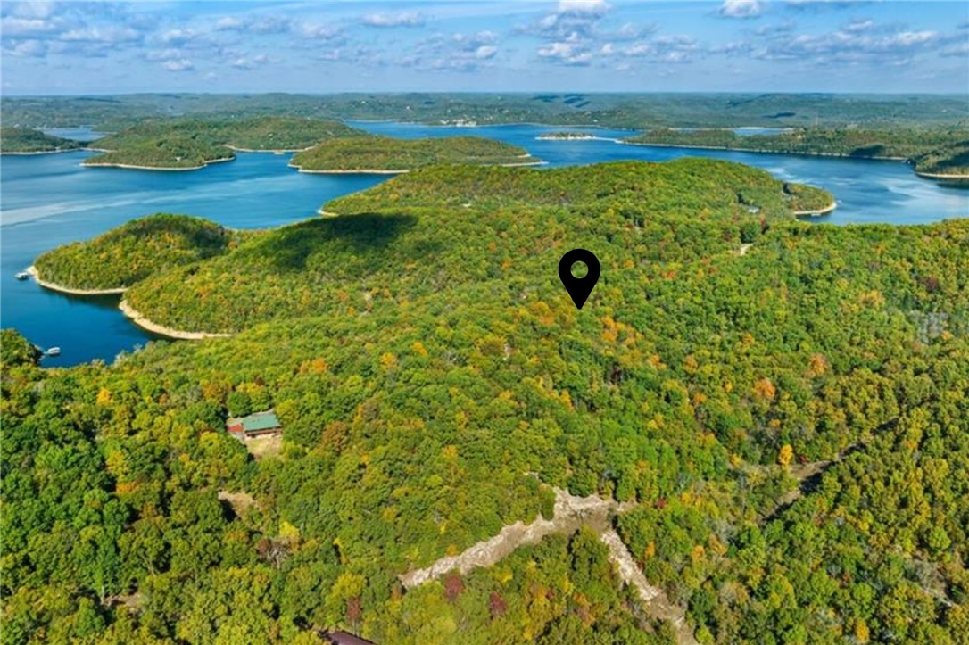 Discover 3 beautiful acres of wooded Ozark hillside, just minutes from Starkey Marina, and the clear waters of Beaver Lake! Minutes in the other direction will take you to Beaver Dam area and trout fishing on the White River. This parcel offers peaceful privacy nestled beneath the canopy of mature trees. Your future build will enjoy easy access via paved roads. Located a short drive from the Lake Leatherwood mountain bike trails as well as downtown Eureka Springs, this property is in a great spot for relaxation and recreation. Light deed restrictions will preserve neighborhood consistency (including no mobile homes.) Short-term rentals are allowed. Bring your vision and create a dream home/cabin or investment getaway in one of Northwest Arkansas' most sought-after lake areas!