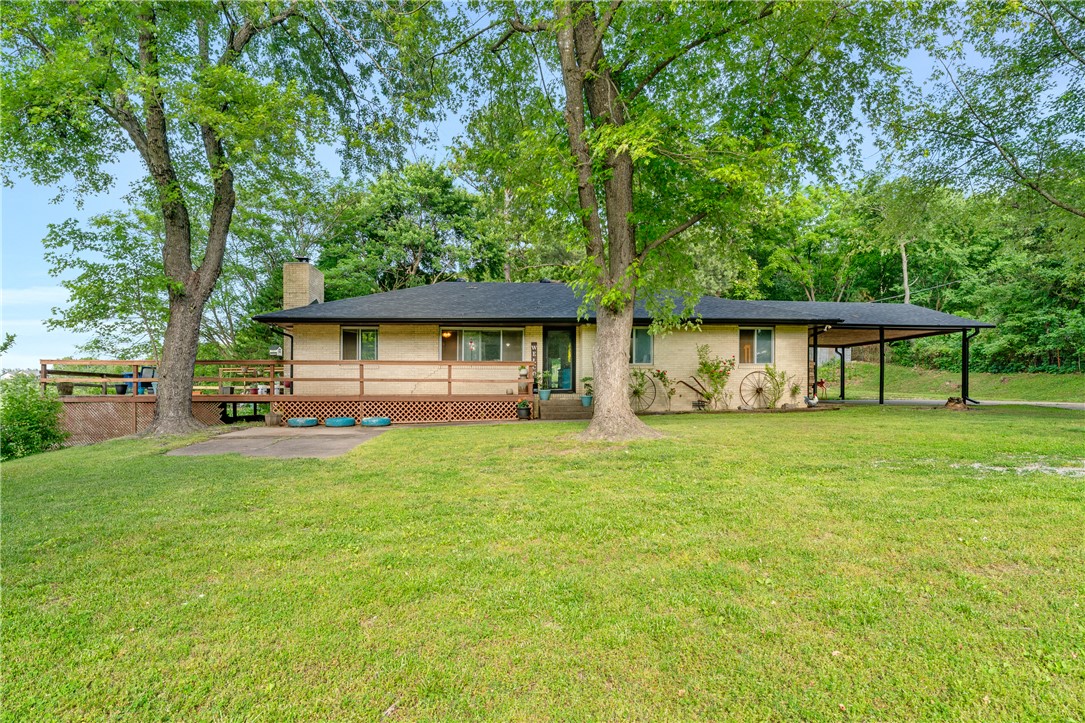 Spacious home in Springdale offering a blend of comfort and peaceful surroundings on 5+ acres. Step inside to a large living room, the perfect focal point for relaxing evenings or gathering with guests. The kitchen offers generous cabinet storage, ample counter space and a functional layout that connects seamlessly to the dining area, along with a pantry and convenient eat-in space for everyday meals. Primary bedroom provides a comfortable retreat, while two additional bedrooms offer flexibility for family, guests, or a home office. Enjoy outdoor living with a patio, deck space and scenic surroundings with room to relax and appreciate the outdoors. The property also features a 30x40 shop with concrete floors, electric and well water, while the home is connected to city water, along with a small barn, storage building and chicken coop for added versatility and country charm. Conveniently located with easy access to schools, parks, dining, shopping, and major roadways while still offering a peaceful setting.