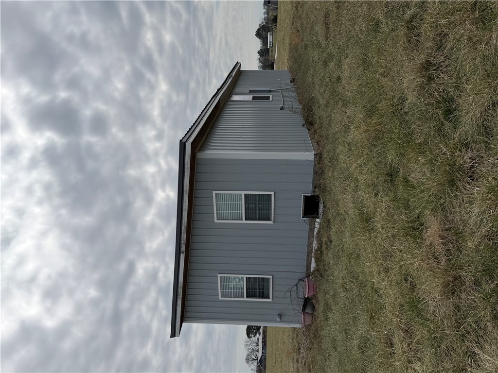 5.05 acres of clear, level land in a peaceful rural setting with existing utilities already in place. Property includes on-site electric, water, and an existing septic system.  The land is open and usable, with some natural overgrowth adding privacy. A fenced area is also present on the property. Located just minutes from Gravette, with nearby growth and new construction in the surrounding area, this property offers excellent potential for residential or investment use.