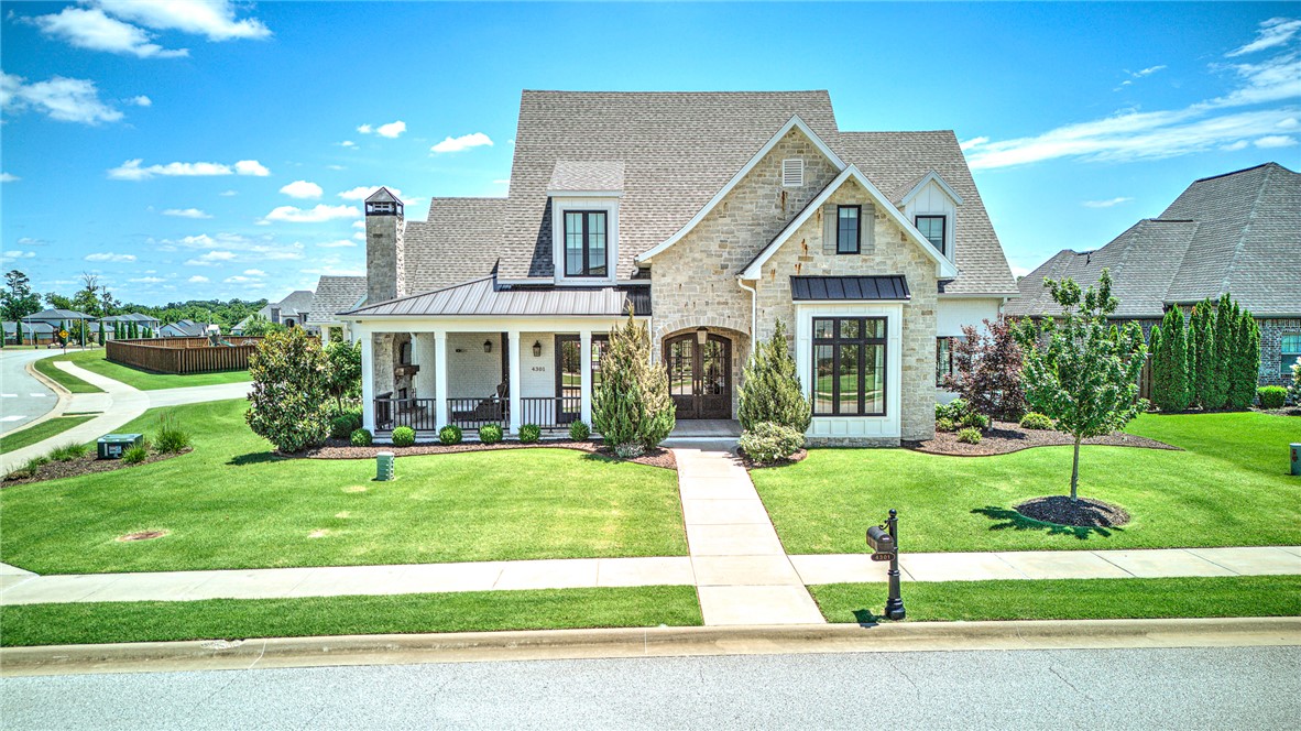 Welcome to an architectural masterpiece where distinct European style meets warm Southern hospitality. Nestled on a corner lot in an exclusive gated enclave, this David Harris custom home boasts unrivaled curb appeal, anchored by a welcoming wraparound porch with a wood-burning fireplace. Inside, beautiful wood floors flow throughout the 4-bed/4-bath layout. A formal dining offers French door access to the charming front porch while the open great room features a wood-beamed ceiling, fireplace w/ built-ins, and a wall of French doors opening to a covered patio for seamless indoor-outdoor living. The gourmet kitchen is a chef’s dream, blending high-end functionality with transitional elegance. The main-level primary retreat features a marble spa-like bath w/ soaking tub!  A flexible main-level study/4th bed sits adjacent to a stylish full bath. Upstairs hosts a bonus rm, 2 en-suite bedrooms, & w/in storage. A sunlit office nook, mudroom, & flat backyard w/ lush gardens & covered patio complete this exceptional home!