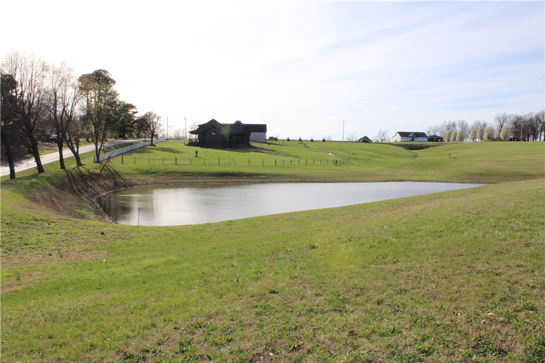 Nestled in a quiet subdivision in Tontitown, this beautiful 5.98-acre lot offers the perfect blend of space, privacy, and convenience. Featuring gently rolling hills, a pond, and several mature trees, the property provides a picturesque setting for your future home while still allowing plenty of open space to design the layout you’ve always envisioned.

Located in a small subdivision with larger estate-sized lots, the property includes protective covenants to help maintain the quality and character of the neighborhood. Water, electric, and natural gas are available at the street, and a septic system will be needed.

With a minimum build requirement of 2,500 square feet, this lot is ideal for creating a spacious custom home surrounded by nature. Enjoy peaceful country-style living while still being just minutes from the conveniences of Northwest Arkansas.

Bring your builder and start planning your dream home today.
