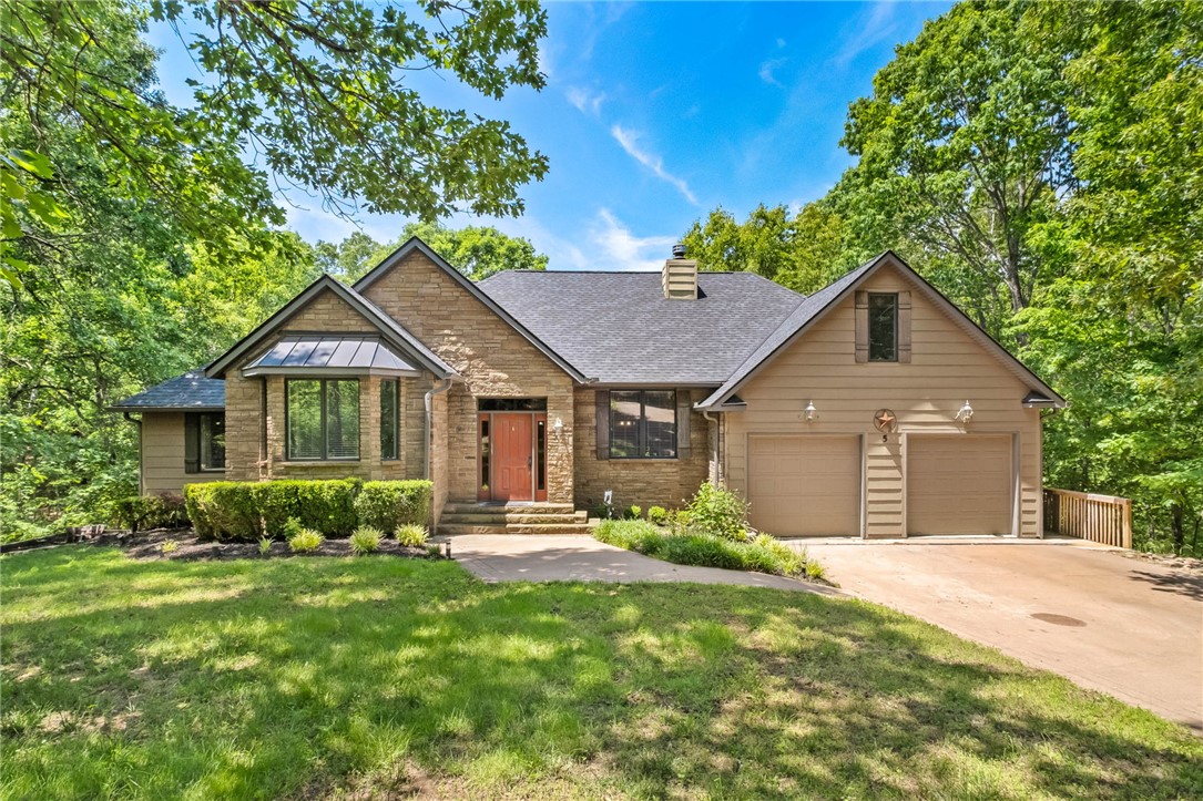 Unique opportunity to buy your own Cul-de-sac and a piece of Bella Vista Paradise.  5 Jodrell Lane sits on 6 lots or 2.40 Acres with a 3564sq' home + additional 400sq' Bonus Room over the garage nestled in the trees.  A quality built 4 bdrm, 3.5 bthrm home has poured concrete walls, tankless water heater, low E windows & a sprinkler system for the yard, The living room has vaulted wood beam ceiling, stone woodburning fireplace, built-in shelving and real hardwood floors.  A large eat-in kitchen has Knotty Alder Cabinets, Center Island with Butcher Block Top, Pantry & French doors leading out to a covered upper deck overlooking the trees.  Large primary bedroom features a trey ceiling, newer carpet, walk-in-closet, and ensuite w/  Jacuzzi, Glassed Shower, & double sinks.  Two other bedrooms, full bath, Mud/Laundry Room & 1/2 bath are also on main floor.  The LL walk-out basement has its own full kitchen & bar, 4th bdrm & full bthrm & large family room & stackable Washer/Dryer. LL & side deck. 2.5 garage w/ workshop.