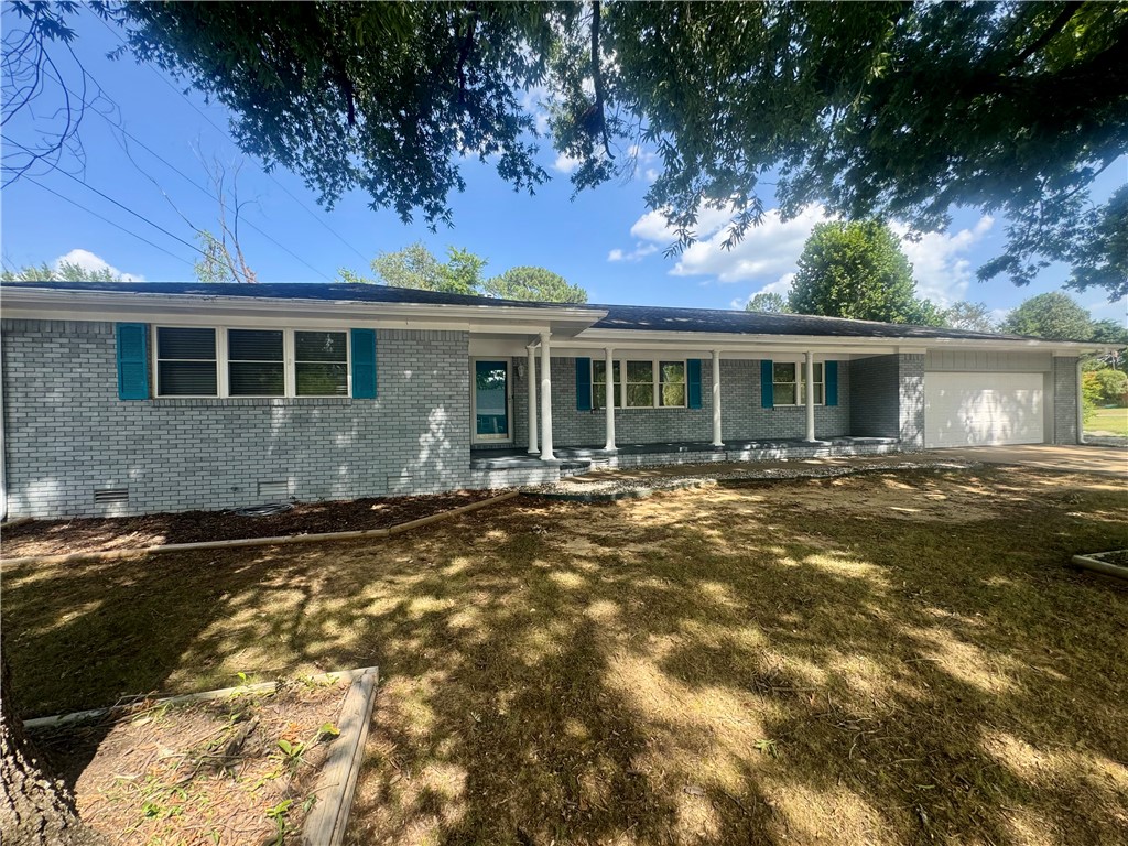 Located in West Russellville, this 4-bedroom, 2.5-bath, 2,589 sq ft home comes packed with modern updates throughout. Outside features covered Patio perfect for grilling or entertaining. The exterior features painted brick, teal shutter accents, and a long covered front porch. Inside, continuous flooring flows through the open main living and formal dining areas. The updated kitchen includes quartz countertops, grey shaker cabinets, a subway tile backsplash, a gas range, stainless appliances, and a peninsula with bar seating. The primary suite features an attached bath with a double vanity and a tiled walk-in shower. Three remaining bedrooms allow flexibility for guests, hobby room or a home office. Complete with a 2-car garage and a concrete driveway with ample parking. Easy to show! Schedule your appointment today!