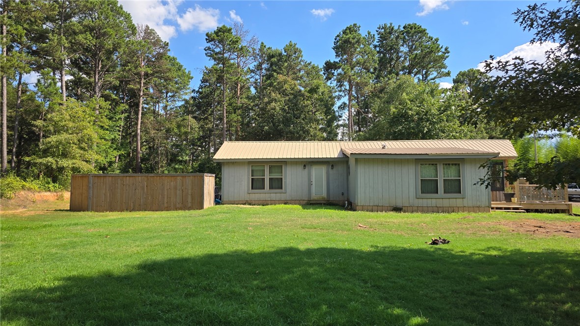 This beautifully remodeled 4-bedroom, 2-bath home sits on 1 peaceful acre and offers the perfect blend of rustic charm and modern comfort. Completely renovated in 2022, the home features an inviting open-concept floor plan with a warm cabin-style feel. Built with efficiency in mind, the home is spray foam insulated on all exterior walls and the roof, helping provide year-round comfort and lower energy costs. Enjoy the country setting in the spacious sunroom porch. Outside, you'll find a large workshop/shop building with plenty of room for projects, storage, or hobbies. Gardening enthusiasts will love the large raised garden bed, while the established fruit trees. The property also includes an RV hookup with electric and septic already in place—simply run a water line to create a full hookup. If you've been searching for a move-in-ready country home with space, energy efficiency, room to garden, and investment potential, this property is one you won't want to miss. Schedule your private showing today!