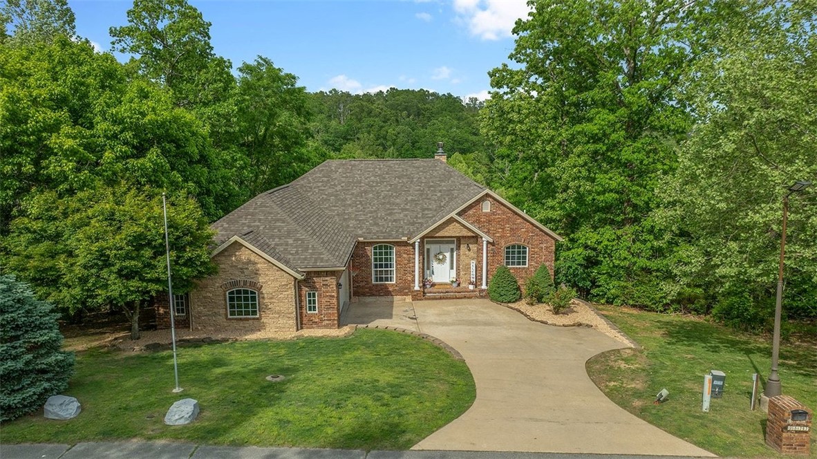 Tucked away in a private, gated community surrounded by natural wooded beauty, this stunning home offers the perfect blend of seclusion and convenience. Enjoy a peaceful, country-like setting while being just 3 minutes from downtown Rogers and only 5 miles from Prairie Creek Marina. This beautifully updated home features hand-scraped wood floors, granite countertops throughout, and upgraded lighting fixtures that elevate the space with a modern touch. Recent exterior improvements include new architectural shingles and new gutters, providing both style and peace of mind for years to come. Take in the serene, seasonal lake views and unwind in a setting that truly feels like a retreat. With its ideal location close to dining, shopping, and outdoor recreation, this home offers the best of both worlds—privacy and accessibility. Don’t miss the opportunity to own a home where comfort, quality, and location come together seamlessly. Pics with furniture are virtually staged.