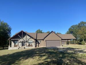 This charming, 6-year old home offers the perfect blend of comfort and space on 5.13 peaceful acres. The house offers 3 bedrooms, 2 full bathrooms, an office/ bonus space, and an attached garage, plus an attached double carport for extra parking. Enjoy your mornings and evenings on the covered front and back porches, perfect for relaxing and enjoying your property.As a bonus, this property includes a 1200 square foot heated and cooled workshop-ideal for hobbies storage or a small business-and a 600 square foot heated and cooled efficiency apartment, great for guests, rental income, or visiting family. The apartment also has its on porch, shaded by mature trees creating a cozy retreat. This home is perfect for those looking for space, privacy and flexibility.