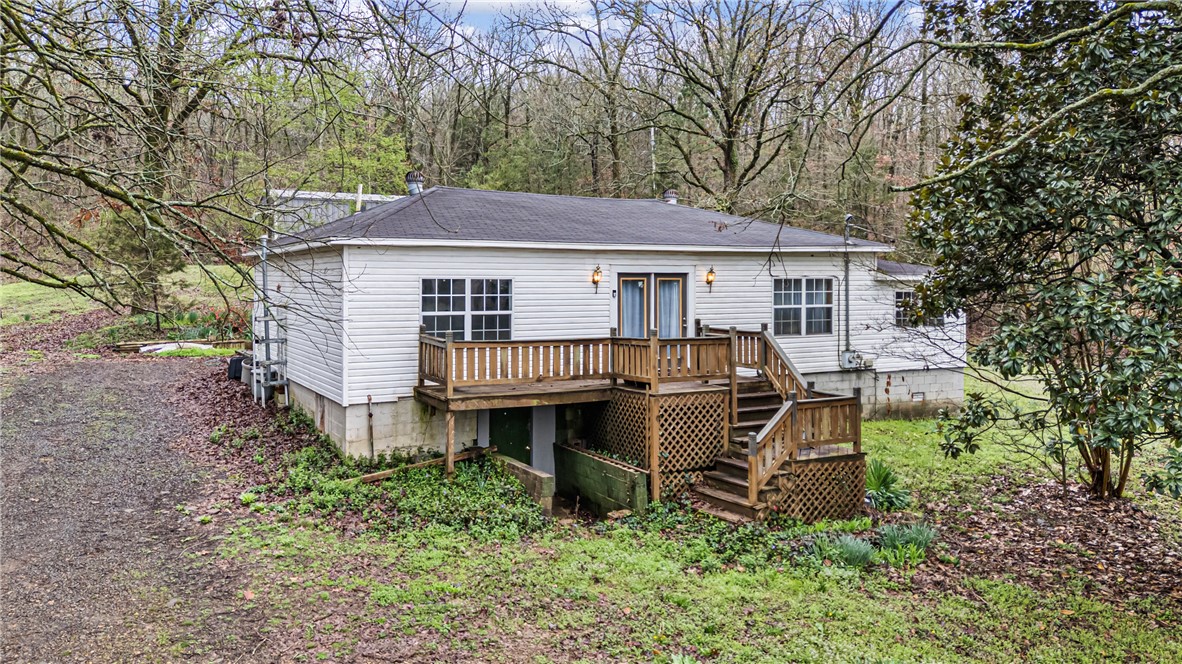 Room to Roam and Space to Create!  This approximately 5.6 acre property is minutes town and offers its owners the perfect combination of open land and wooded seclusion.  The 1,580 sq ft home features 3 bedrooms, 1 bathroom, a spacious living room, and an eat-in kitchen.  With great bones and room to personalize, it's ready for someone to make it their own. The real standout is the approximately 2 acres of cleared land, full of natural light and ideal for outdoor living, gardening, play space, or creating your own country oasis. The remaining 3 acres of timber provide privacy, shade, and space to explore. A 30x40 fully electric shop offers incredible versatility with plenty of room for equipment, projects, or storage. Inside, a separate enclosed room creates the an opportunity for a home office, hobby space or even future apartment potential. If you've been searching for acreage with flexibility and convenience, this property is full of opportunity.