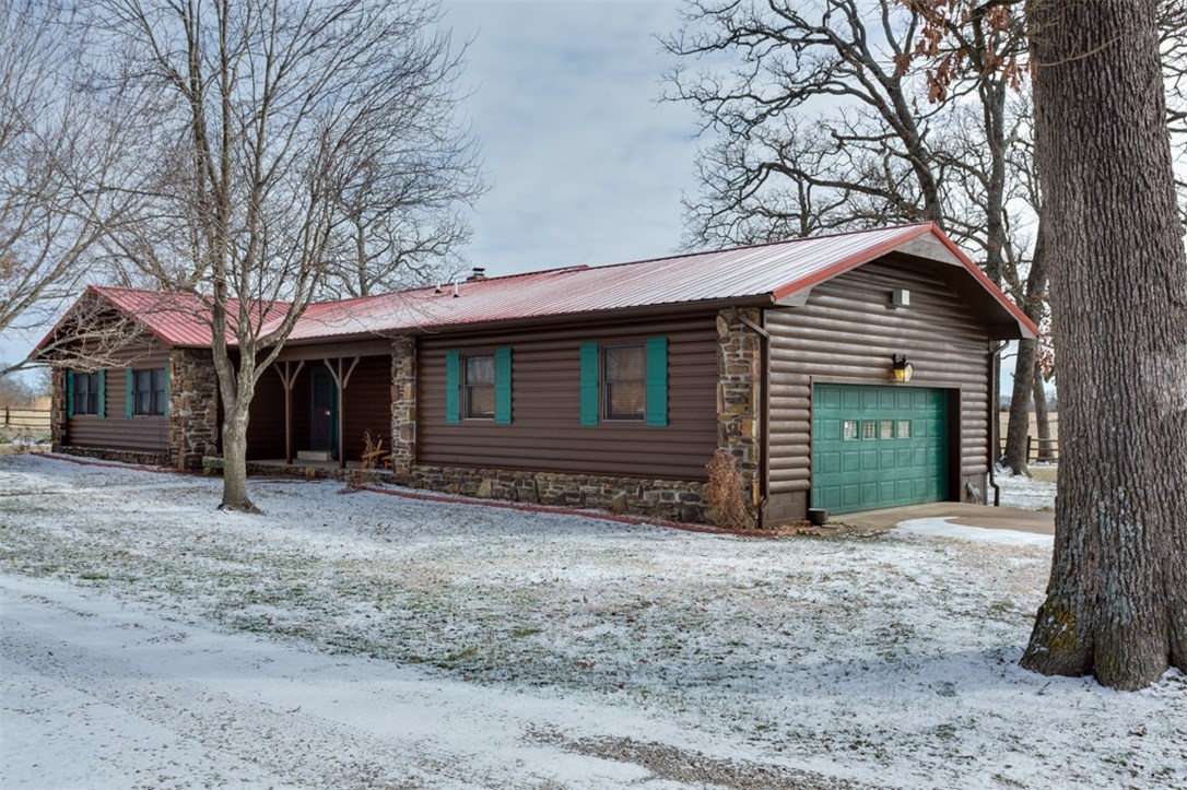 Ranch style home, shop, barn, & land for livestock. 2,092 sq ft 3 bed/2 bath completely remodeled in 2013 w living room & master bedroom extensions. Watch the sunrise on East facing covered deck w extension; 30.92 total acres (85% pasture) with water in 5 separate pastures, 2 ponds, 50x50 shop has 20' overhang, hunting/office room w htmp & woodstove, 60'x40' barn has tack room, electric, & concrete floor. New metal roof in 2011, livestock shed. One mile from Pea Ridge city limits.